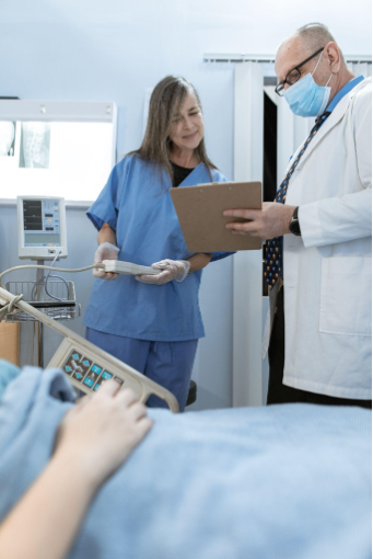 medical assistant getting directions from a doctor